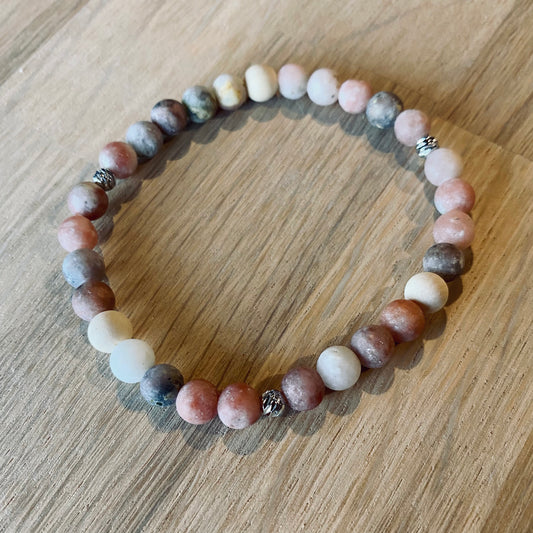 Mixed Marble Aroma Bracelet - 6mm beaded diffuser bracelet made from mixed marble & natural white wooden beads with platinum plated balls as embellishments. Laid flat on wood grain surface. 